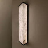 Eryndor LED Alabaster Wall Light in matt black and soft white, tall rectangular alabaster panel with black metal edges, illuminated on a neutral wall.