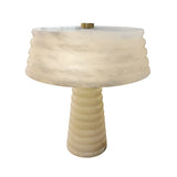 The Orivon 3 Light Sculpted Alabaster Table Lamp in Soft White features a cylindrical, ridged base and wide matching shade, both in marble-like alabaster for a smooth, modern look.