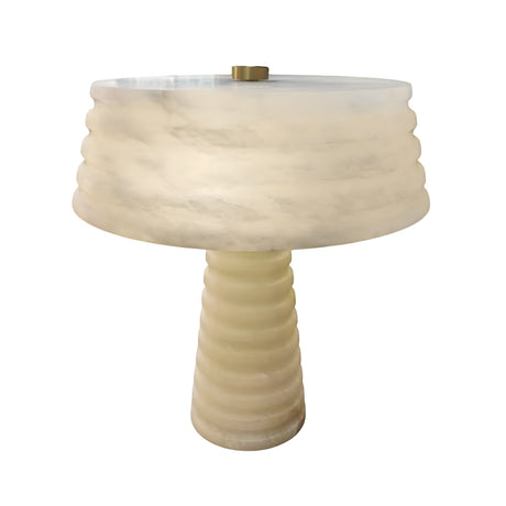 The Orivon 3 Light Sculpted Alabaster Table Lamp in Soft White features a cylindrical, ridged base and wide matching shade, both in marble-like alabaster for a smooth, modern look.