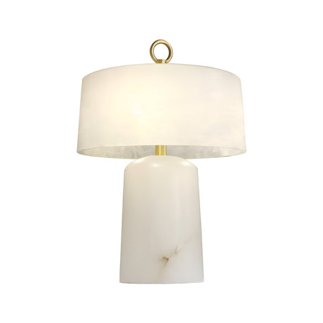 The Calyra 3 Light Solid Form Alabaster Table Lamp – Soft White features a white cylindrical marble base, wide matching shade, brass accents, and a gold ring on top for elegance. It delivers warm ambient lighting when switched on.