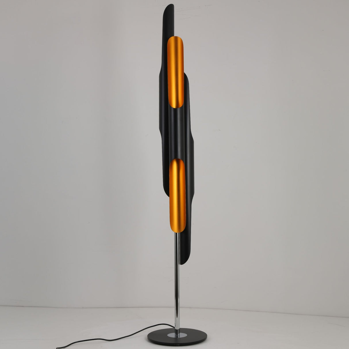 Niori Stealth 6 Light Floor Lamp with staggered matt black tubular shades and brushed brass interiors on a polished chrome stem and round black base.