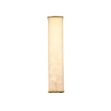 The Valmere LED Medium Linear Alabaster Wall Light in Soft White features a tall, cylindrical design with a smooth, neutral-colored shade and emits a soft, warm glow.