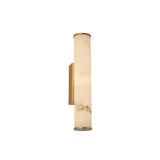 The Montavo LED Small Tube Alabaster Wall Light in soft white and brushed brass features a cylindrical frosted glass shade with marble-like patterns, recalling the elegance of Spanish alabaster lighting on a sleek rectangular base.