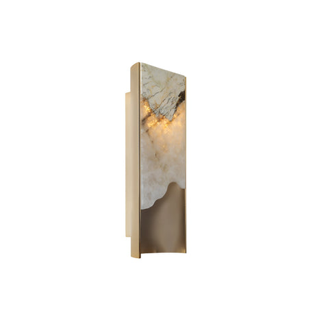 The Veloris LED Small Carved Alabaster Wall Light in brushed brass and soft white features a marble-like upper section and smooth metallic lower section, casting a warm glow from behind its compact, modern rectangular panel.