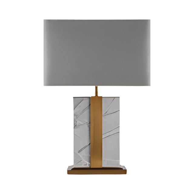 The Elvaris 1 Light Framed Marble Table Lamp features a brass accent, rectangular grey shade, and a base of white marble with gray veins atop a brass and marble platform.