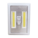 LYYT LED Battery Switch Light in white, with two yellow COB LED strips flanking a centre rocker switch on an ABS housing, shown on a plain background.