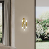 TheLight LED Wall Light in satin gold finish with three slim iron arms lit at both ends by frosted acrylic diffusers, mounted on a bedroom wall.