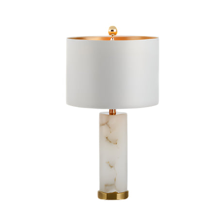 The Calix 1 Light Faceted Pillar Alabaster Table Lamp features a brushed brass base and soft white shade, offering elegant ambient lighting with its modern design against a white background.