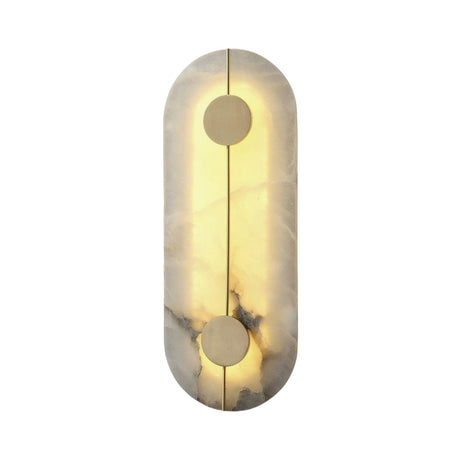 The Elaris LED Capsule Alabaster Wall Light in soft white and brass features a modern, elongated oval design with a glowing LED behind an alabaster surface and two central brass accents—one at the top and another at the bottom.