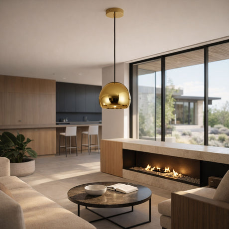 Modern living room with luxury lighting—a Grand Ball Glass Pendant 40cm - Gold, beige sofas, round coffee table with a book, built-in fireplace, large windows, and an open kitchen with light wood cabinets overlooking the patio.