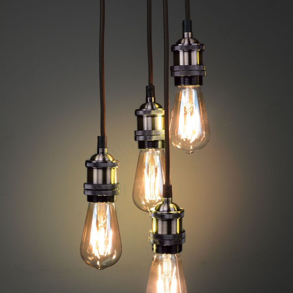 LYYT ES Quad Pendant Set in antique brass by AVSL, four E27 lamp holders on braided cables at staggered drops with lit Edison filament bulbs.