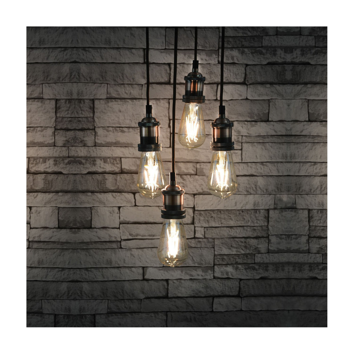 LYYT 4-light pendant set with E27 antique copper lamp holders on black braided cables, fitted with vintage filament bulbs, against a grey brick wall.