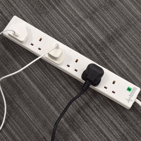 AVSL Mercury 6 Gang Extension Lead with Surge Protection in white with three UK plugs connected, shown on a grey carpeted floor.