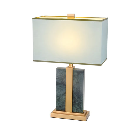 The Elvaris 1 Light Framed Marble Table Lamp in Brass & Green features a rectangular white shade, gold frame, and dark green marble base on a gold platform. Illuminated, it adds a stylish accent to any space.
