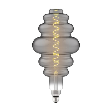 Classic E27 dimmable LED bulb in smoked glass with tiered vintage shape, visible spiral filament, E27 metal base, on a plain white background.