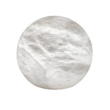 The Noreva 1 Light Sculpted Globe Alabaster Table Lamp features a smooth, round white alabaster sphere with a cloudy, marble-like texture, evoking sculptural lighting. Shown isolated on a white background in soft white.