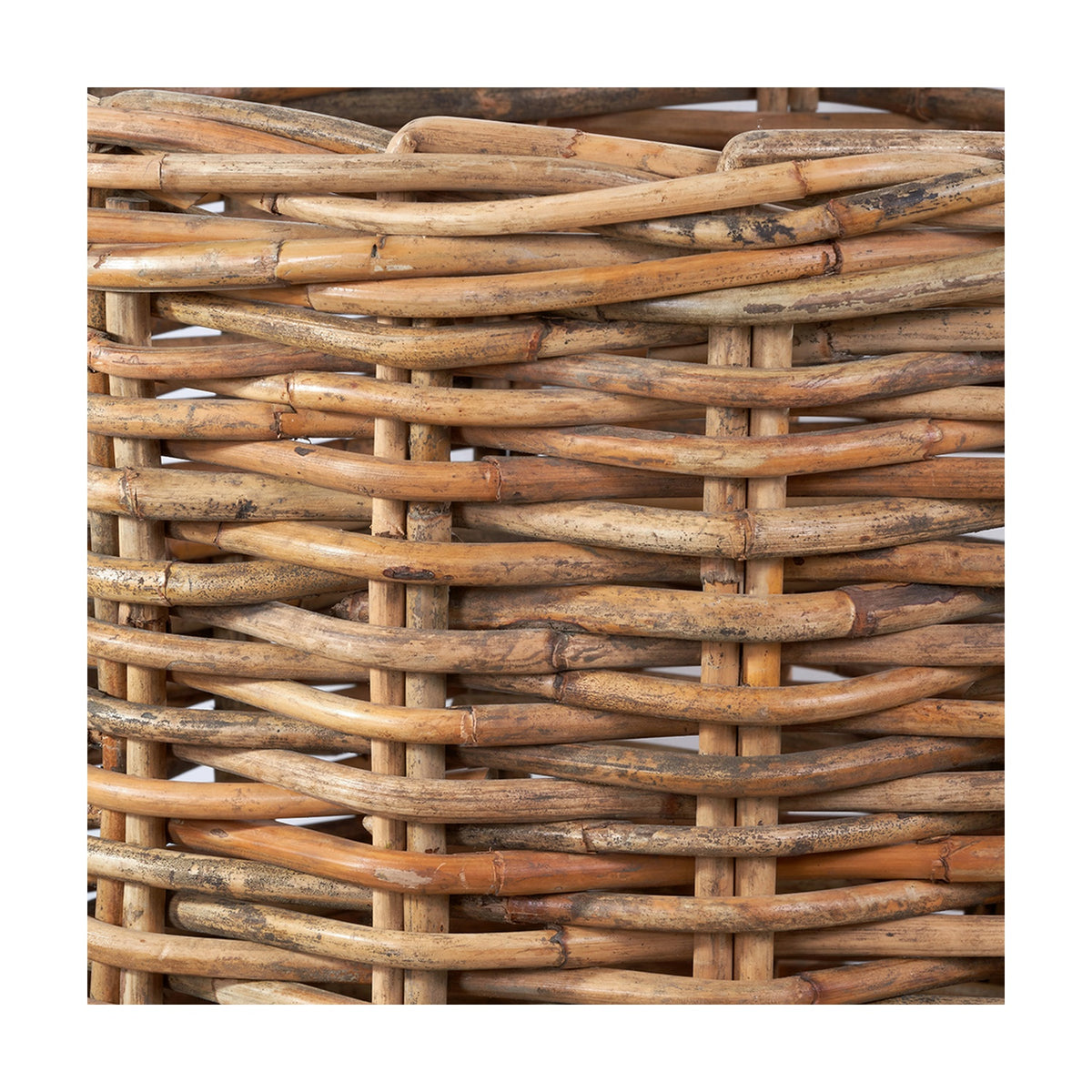 Close-up of a Tobs chunky rattan log basket in natural finish, showing tightly woven wicker strands with visible joins and texture.