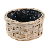 Round grey Kubu rattan basket planter with triple weave design and black plastic liner, shown on a plain white background.