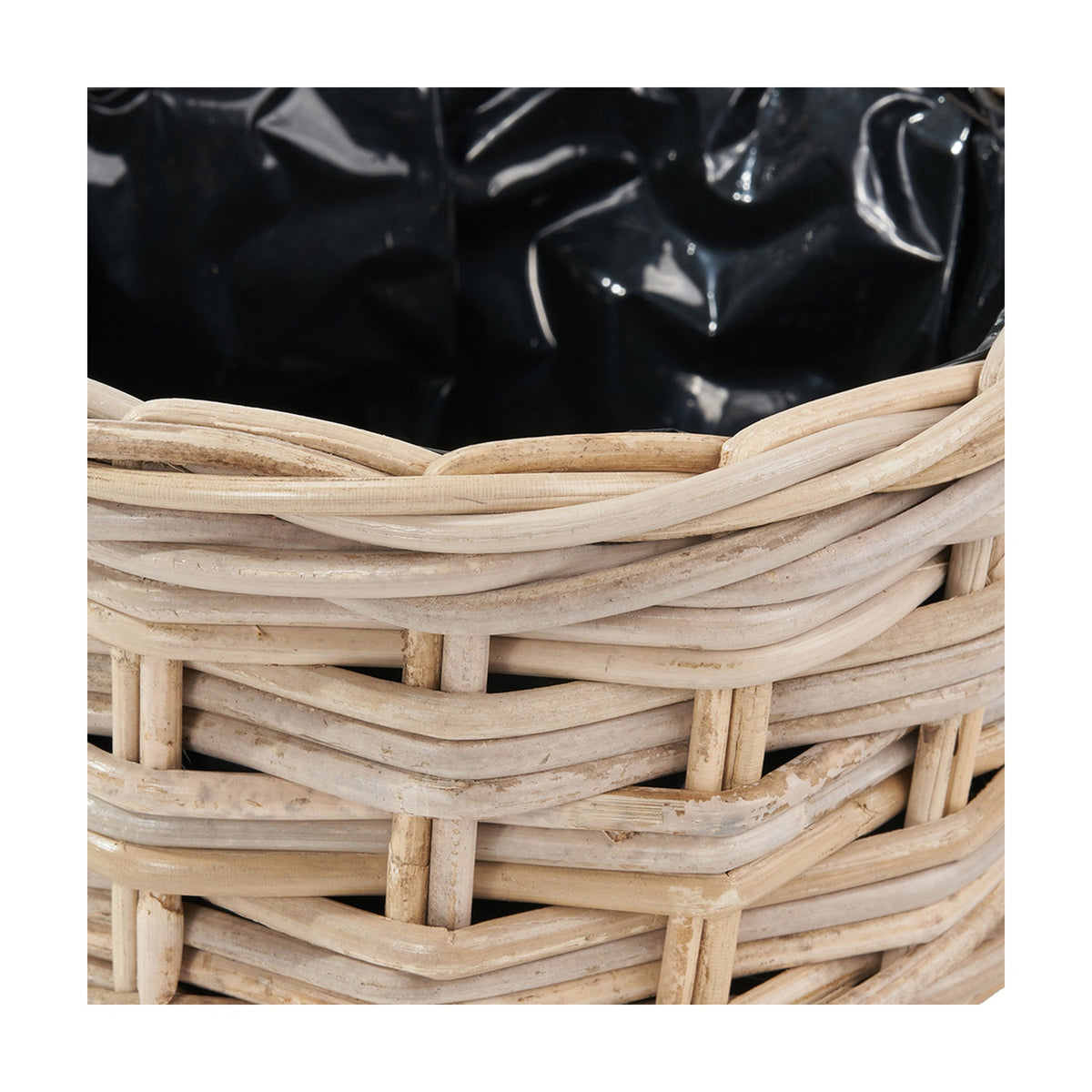 Close-up of the Tobs grey Kubu rattan triple weave basket planter, showing the woven rim detail and black waterproof inner lining.