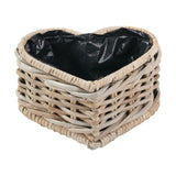 Heart-shaped woven grey Kubu rattan basket planter with a black plastic liner, shown on a plain white background.