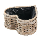 Tobs heart-shaped planter in grey Kubu rattan with woven basket sides and black plastic liner, shown on a white background.