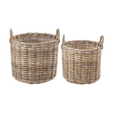 Tobs Set of 2 grey rattan round log baskets, 56cm, woven with looped side handles, shown in graduated sizes on a plain white background.