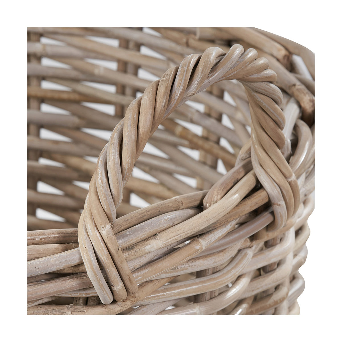 Close-up of the Tobs 56cm grey rattan log basket, showing the twisted woven handle and open lattice weave in soft grey tones.