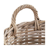 Close-up of a round grey rattan log basket from the Tobs set, showing a twisted woven handle and open weave sides against a plain white background.