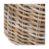 Close-up of the Tobs grey rattan round log basket, showing tightly woven wicker texture with a whitewashed finish over natural wood tones.
