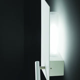 Flat Wall Light with Reading Light in white, featuring a slim iron plate with frosted glass cylinder diffuser and a slender reading arm, mounted on a dark wall.