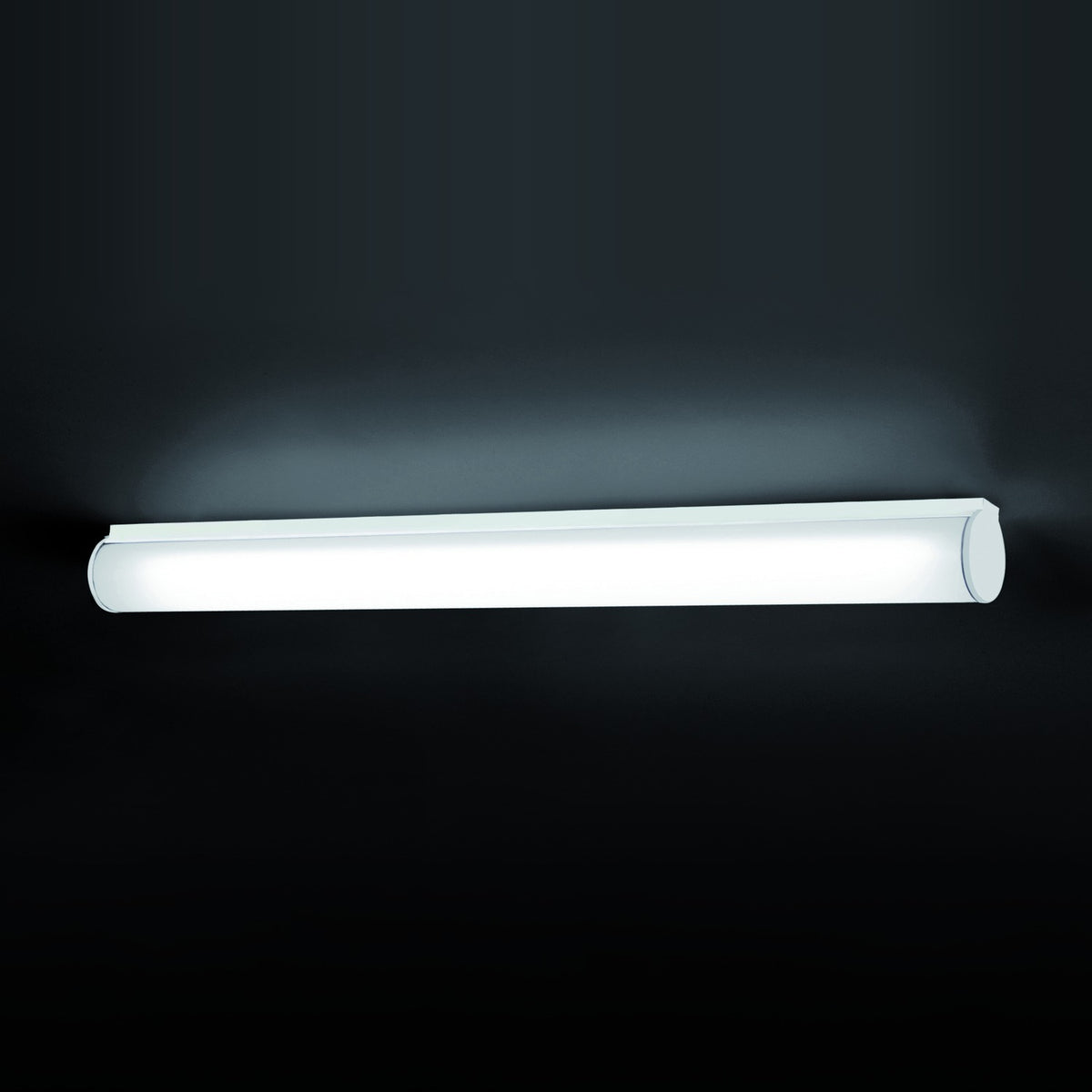 Bath A LED Linear Flush Wall & Ceiling Light in white, a long opal polycarbonate tube on a white iron body with rounded end caps, shown lit against a dark background.