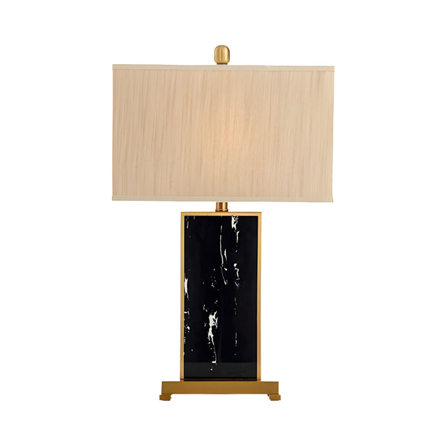 The Valmor 1 Light Block Marble Table Lamp features a modern black marble rectangular base, brass accents, and a large rectangular beige fabric shade, shown against a white background.
