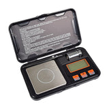 AVSL Mercury 50g/0.001g digital pocket scale in open black case with stainless platform, LCD, orange buttons, tweezers and calibration weight.