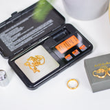 AVSL Mercury Digital Pocket Scale open in its black hard case, weighing a gold chain on the stainless steel platform with backlit orange LCD display.