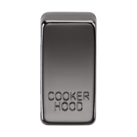 A black nickel rectangular switch cover with embossed text "COOKER HOOD" on its surface reflects light against a white background. Its interchangeable design and durable ABS construction ensure lasting elegance and functionality.