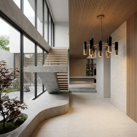 A modern, minimalist interior with floating concrete stairs, floor-to-ceiling windows, a wood slat ceiling, the Leonard 13 Light LED Chandelier in black & gold as a focal point, and a small indoor garden with a Japanese maple tree.