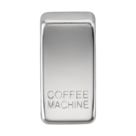 A polished chrome switch cover, marked with "COFFEE MACHINE," gleams against a plain white background, showcasing its smooth and shiny texture.