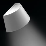 Fennorne Wall Light in white with a silver interior, a single curved iron shade angled on a dark background, casting soft light upward and downward.
