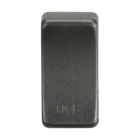 A dark, rectangular object with rounded edges and the engraved letters "HOB" on its surface. This smoked bronze "Switch Cover" embodies a sleek design popular among rock enthusiasts, positioned vertically against a plain white background and providing interchangeable features for customization.