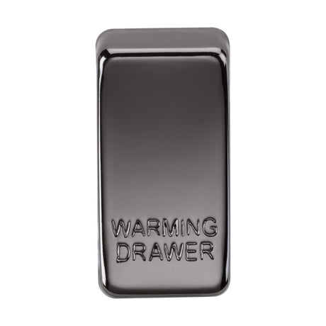 A switch cover marked with "WARMING DRAWER" on its surface, boasting a sleek black nickel finish and a shiny, reflective appearance that adds a touch of elegance.