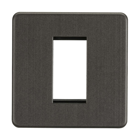 The 1 Gang Modular Faceplate in smoked bronze is a square, plastic cover designed to fit over a single light switch. It features a central rectangular cutout and offers a sleek, screwless design.