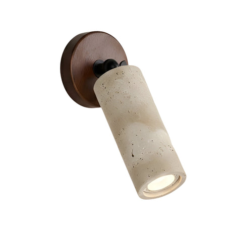 The Korvane 1 Light Travertine Spotlight features a cylindrical, textured light beige shade and a round walnut brown base, mounted on the wall to direct light downward at an angle for a modern touch.