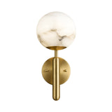 The Etoile 1 Light Sphere Alabaster Wall Light features a marbled soft white glass globe atop a vertical brushed brass fixture, mounted on a circular brass plate for a modern touch.