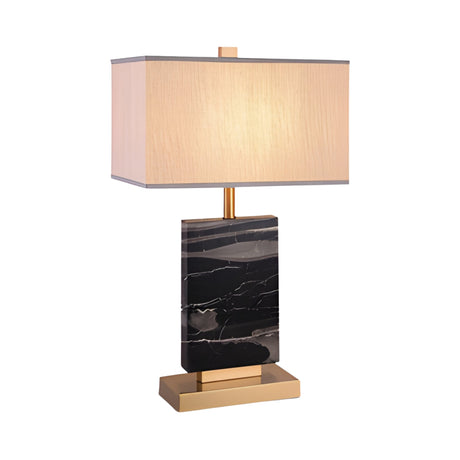 The Caviron 1 Light Block Marble Table Lamp features a vertical black marble base with white veining, brass accents on the base and stem, and a rectangular beige lampshade, all set against a white background.