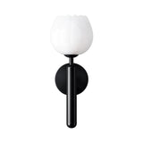 The Olivaro 1 Light Pedal Form Alabaster Wall Light features a soft white flower-shaped glass shade and a matte black cylindrical base, combining modern style with elegant design.
