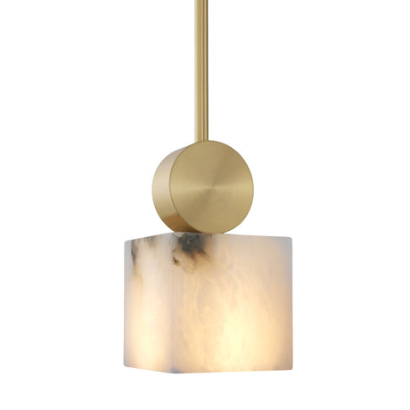 The Serano 1 Light Small Vertical Pillar Alabaster Pendant Light features a soft white cubed shade with natural veining, suspended from a brass fixture on a gold rod, set against a white background.