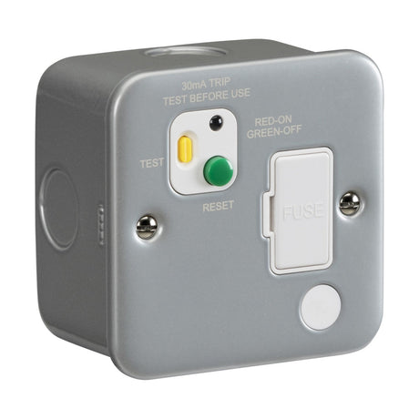 The Metal Clad 13A RCD Fused Spur Unit in gray, features fuse, reset, and test buttons. It comes with a Type A RCD to enhance safety by detecting AC residual current. The phrases 30mA TRIP and TEST BEFORE USE are printed above the buttons.