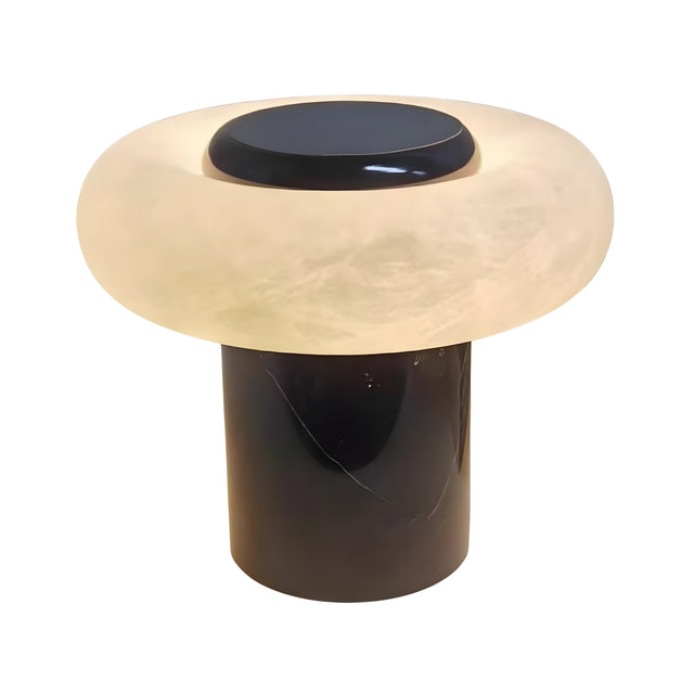 The Orvixa LED Rounded Alabaster Disc Table Lamp features a sculptural design with a cylindrical black base and a wide, soft white translucent shade that glows gently.