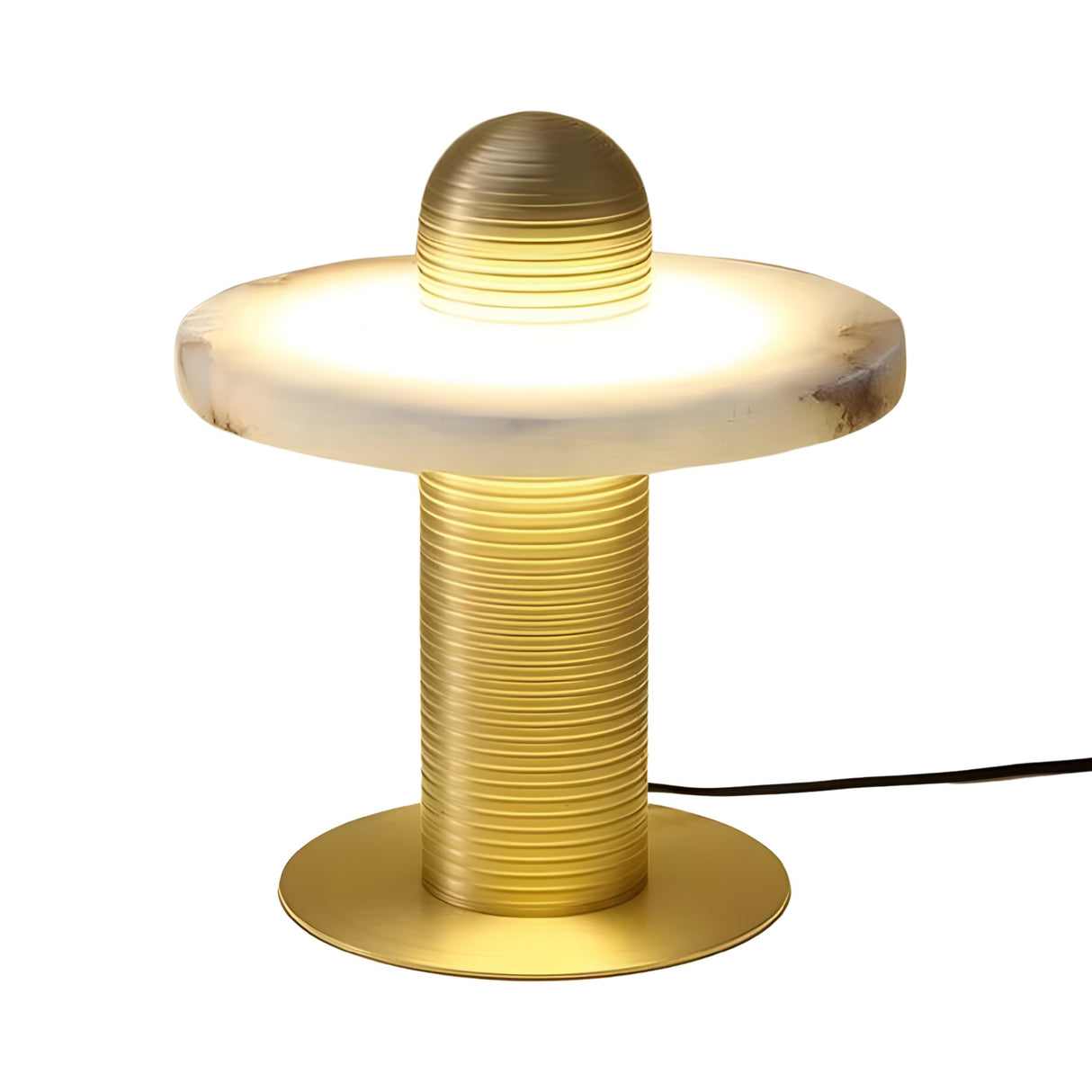 The Nyxara LED Single Tiered Alabaster Table Lamp features a brass ribbed cylindrical base and a wide, white mushroom-style shade, emitting a soft, warm light. Powered by a black cord.