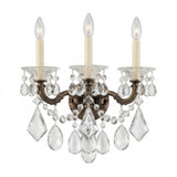 The Vienna 3 Light K9 Crystal Wall Light features three ornate brass arms, candle-style bulbs, and clear K9 crystal prisms and beads, all displayed against a white background.